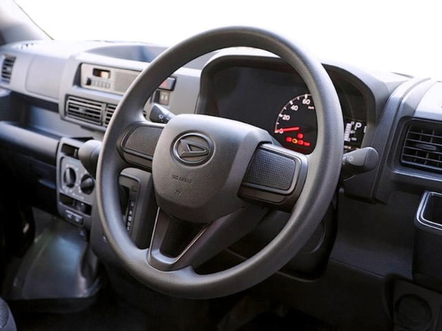 Steering wheel and dashboard in a CVT Daihatsu Hijet Cargo 4x4 Japanese mini truck
