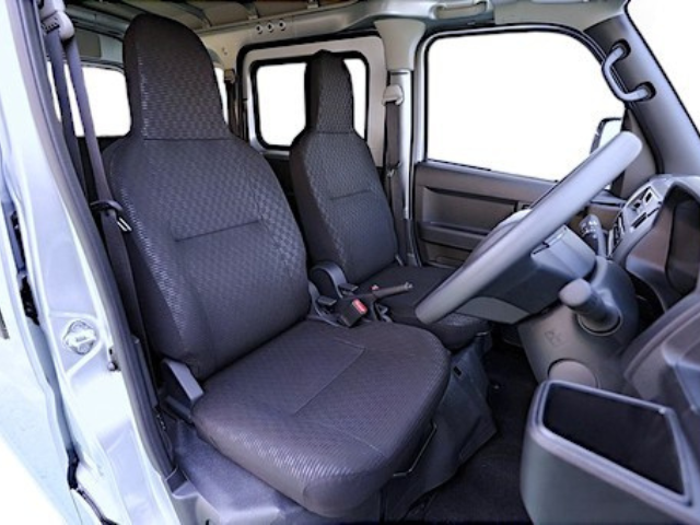 Front seats from the driver's side in a Daihatsu Hijet Cargo 4x4 Japanese mini truck