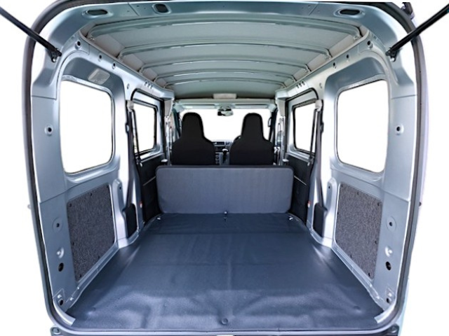 Rear cargo area with rear seat folded out of the way in a Daihatsu Hijet Cargo 4x4 Japanese mini truck