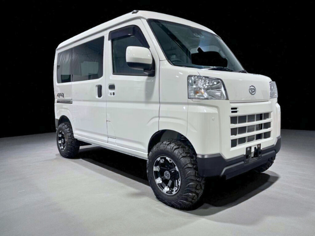 Right-front view of a white Daihatsu Hijet Cargo 4x4 Japanese mini truck