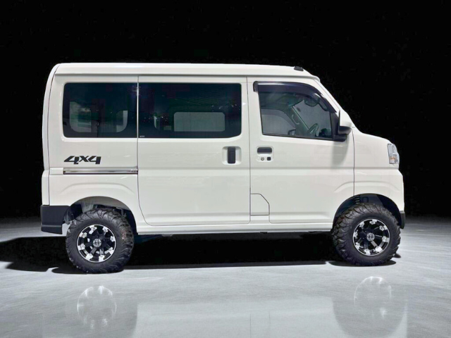 Right side view of a white Daihatsu Hijet Cargo 4x4 Japanese mini truck