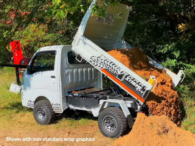 Daihatsu Hijet HD Dump shown from left rear dumping out the sand load from it's rear dump bed