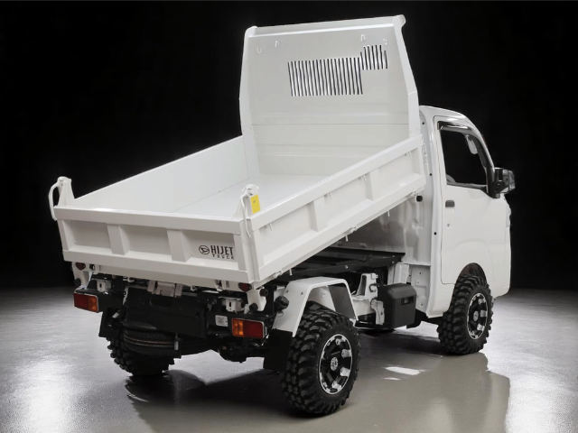 Studio shot of Daihatsu Hijet HD Dump from right rear with bed raised