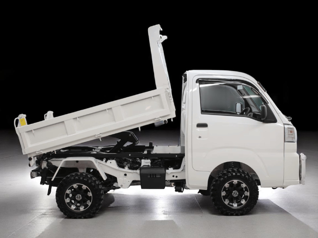 Studio shot of Daihatsu Hijet HD Dump from right side with bed raised