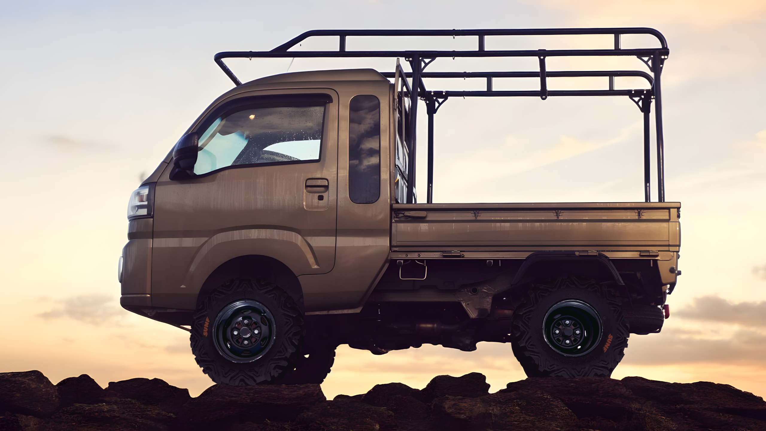 Daihatsu Hijet Jumbo Japanese mini truck from left side against evening sky
