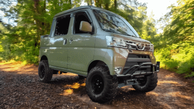 Daihatsu Hijet Deckvan driving off-road in the woods Daihatsu Hijet Deckvan driving off-road in the woods